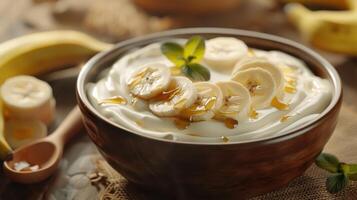 Creamy Yogurt Bowl Topped With Sliced Bananas and Drizzled Honey in a Rustic Kitchen Setting photo