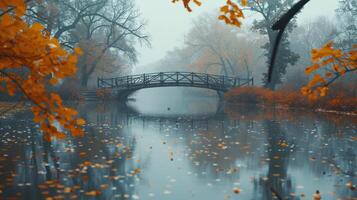 Misty Autumn Morning Reflecting Tranquility Under a Bridge Surrounded by Golden Leaves in a Serene Park photo