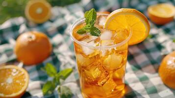 Refreshing Citrus Iced Tea Served With Juicy Orange Slices on a Sunny Day in the Park photo