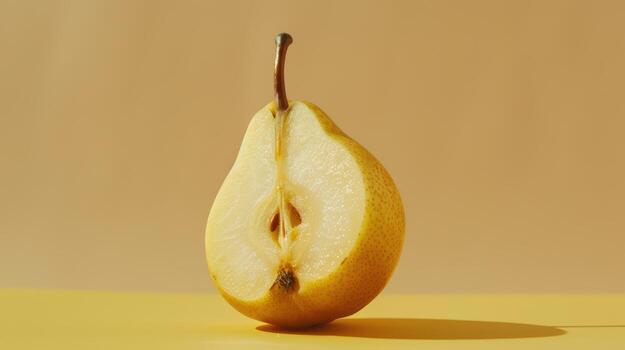 Captivating Close-Up of a Halved Pear Glowing Under Soft Golden Light in a Minimalist Setting photo