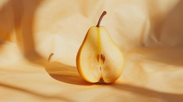 Captivating Yellow Pear Halved on Soft Golden Silk Fabric in Warm Ambient Light photo