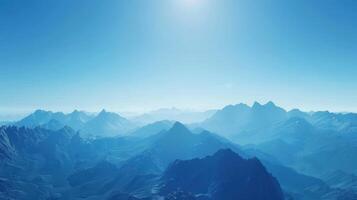 Majestic Mountain Range Under Clear Blue Sky During Serene Morning Light photo