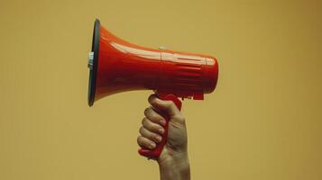 A Vibrant Red Megaphone Held High Against a Bright Yellow Background During a Public Rally in Early Spring photo