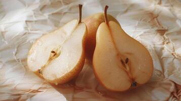 Freshly Cut Pears Glimmering in Soft Natural Light on Crumpled Textured Paper in the Morning photo