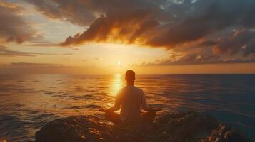 Serene Meditation at Sunset Over Calm Ocean Waves on a Peaceful Rocky Shoreline photo