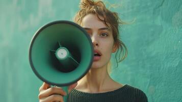 Passionate Activist Expressing Her Voice With a Megaphone Against a Vibrant Aqua Wall photo