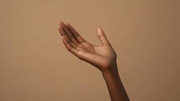 Elegant Gesture of an Outstretched Hand Against a Neutral Background in Natural Lighting photo