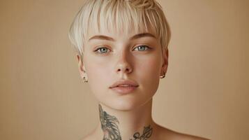 Model With Short Blonde Hair and Tattoos Poses Against a Neutral Background in a Studio Setting photo