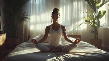 A person peacefully meditates in a bright, calming space filled with greenery photo
