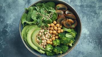 Colorful Vegan Bowl Featuring Spinach, Chickpeas, Avocado, Mushrooms, and Broccoli Perfect for Nutritious Lunch or Dinner photo