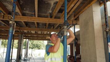 Bricklayers Working on Building Construction, Bricklayers are working on a multi-story building, stacking bricks and constructing walls. video