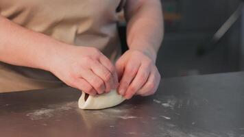 Close-up of female hands making cookies with chocolate filling. Making envelope cookies with chocolate by hand video