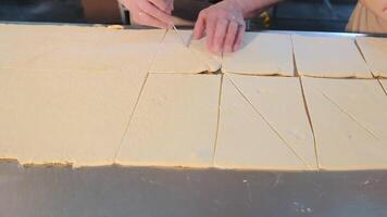 Cutting the dough into triangular pieces. The concept of making bagels, croissants video