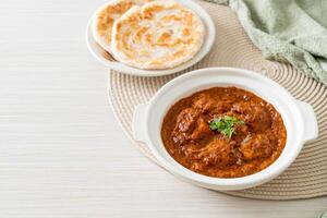 chicken tikka masala spicy curry meat food with roti or naan bread photo