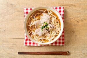 homemade udon noodles with pork in soy or shoyu soup photo