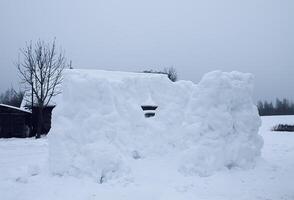 Wall made of snow on rural field photo