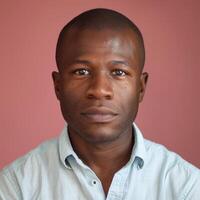African American Man Posing Confidently Against Solid Pink Background photo