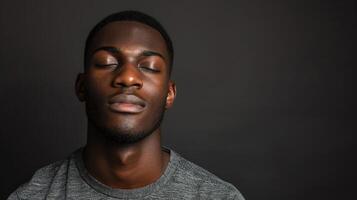 African American Man With Closed Eyes in Solid Background Setting photo