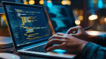 Software developer working on laptop showing code on screen at night photo