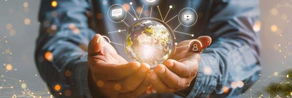 Global connection and innovation, businessman holding glowing earth with social media icons overlaid photo