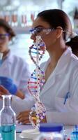 Team of scientists working with dna model in laboratory photo