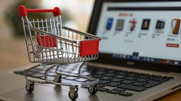 Shopping cart standing on laptop keyboard online shopping concept photo