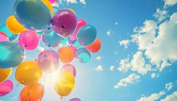 Bunch of colorful helium balloons floating in the sky photo