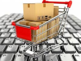 Shopping cart full of cardboard boxes standing on laptop keyboard photo