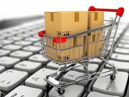 Shopping cart full of cardboard boxes standing on laptop keyboard photo