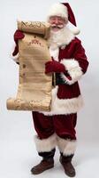 Santa claus holding long christmas wish list smiling on white background photo