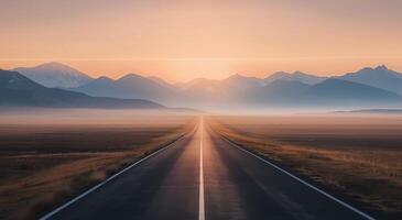 Sunrise Over Long Stretch of Road in Mountainous Landscape photo
