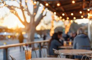 Outdoor Pub Gathering at Golden Hour With Beer Glasses and Warm String Lights photo