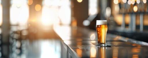 Craft Beer Glass on Bar Counter in Warmly Lit Brewery at Sunset photo