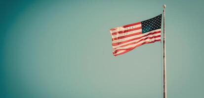 American Flag Waving Against Clear Blue Sky During Daytime photo