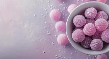 Colorful Candy Bowl With Purple and Pink Confections on a Soft Background photo