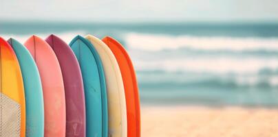 Colorful Surfboards Lined Up on a Beach Shore by the Waves in Bright Sunlight photo