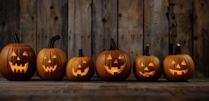 Row of Carved Halloween Pumpkins On a Wooden Deck at Night photo
