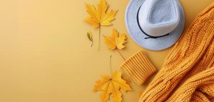 Cozy Autumn Accessories With Leaves on Yellow Background photo