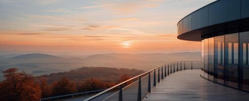 Modern Architecture Overlooking Mountain Landscape at Sunset photo