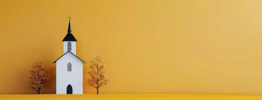 Small White Church With Black Spire Surrounded by Yellow Landscape and Autumn Trees photo