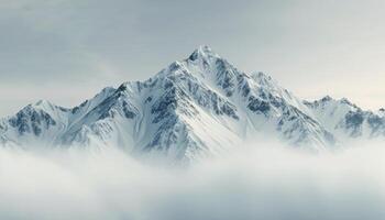 Snow-Capped Mountains Emerging Through Misty Clouds in a Serene Landscape photo