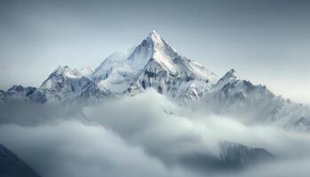 Snow-Capped Mountains Emerging Through Misty Clouds in a Serene Landscape photo