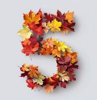 Colorful Autumn Leaves Arranged in Shape of Number Five on White Background photo