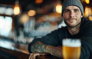 Young Man in Beanie Enjoying Beer at Cozy Bar During Evening Hours photo