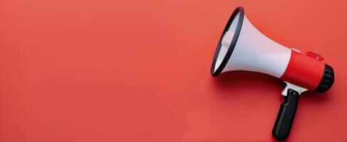 Megaphone Positioned on Red Background for Announcements and Communication photo