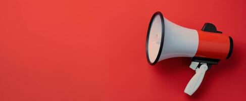 Megaphone Positioned on Red Background for Announcements and Communication photo