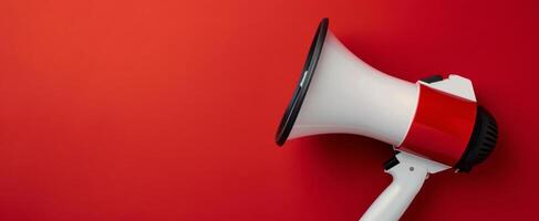 Megaphone Positioned on Red Background for Announcements and Communication photo
