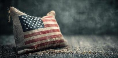 Burlap Pillow With American Flag Design on Rustic Surface photo
