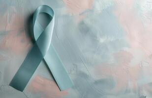 Light Blue Awareness Ribbon on Gray Surface photo