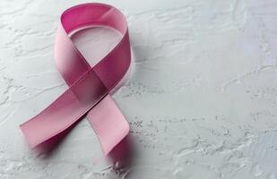 Pink Ribbon on a Light Gray Surface for Breast Cancer Awareness Month photo
